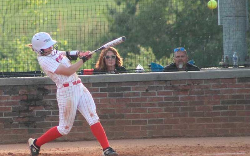Suzanna Cabe knocks a ball into center field versus West Henderson April 28. (Press photo/Will Woolever)