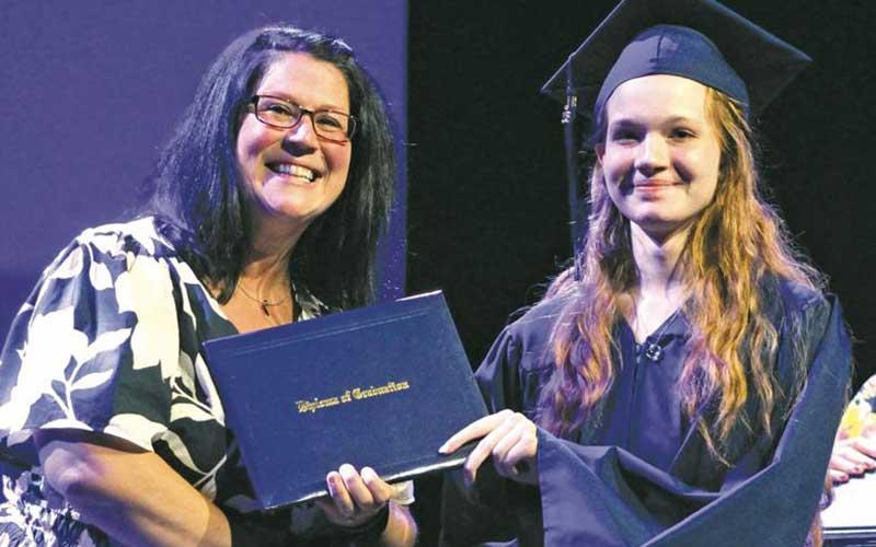 Press photo/Shelby Powell - Patience Eicher receives her diploma from Bartram Academy principal Nikki Oberley. See more photos on Page A6 and on The Franklin Press Facebook page.