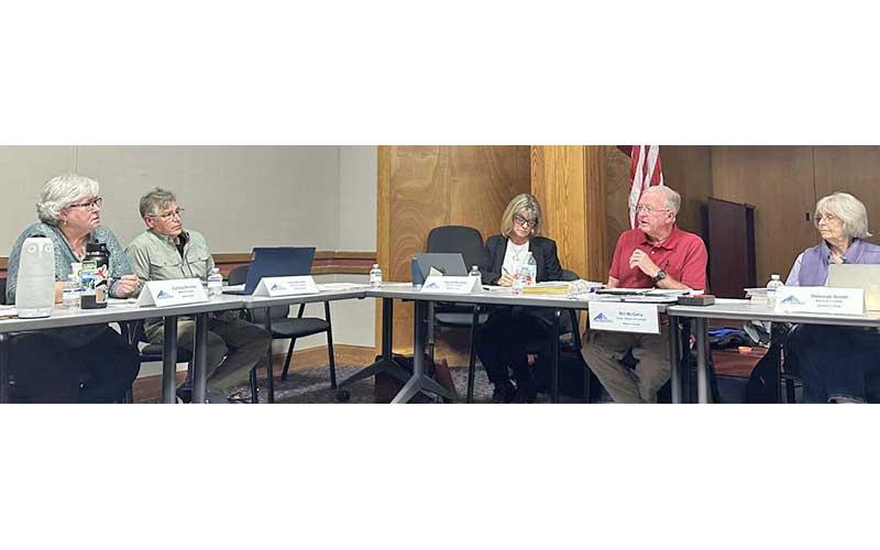 Highlander photo/Mitch Stone - FRL Board Chair Bill McGaha and Cynthia Womble discuss whether Swain County should receive a higher percentage of net surplus funds due to the free rent it has provided for FRL headquarters.