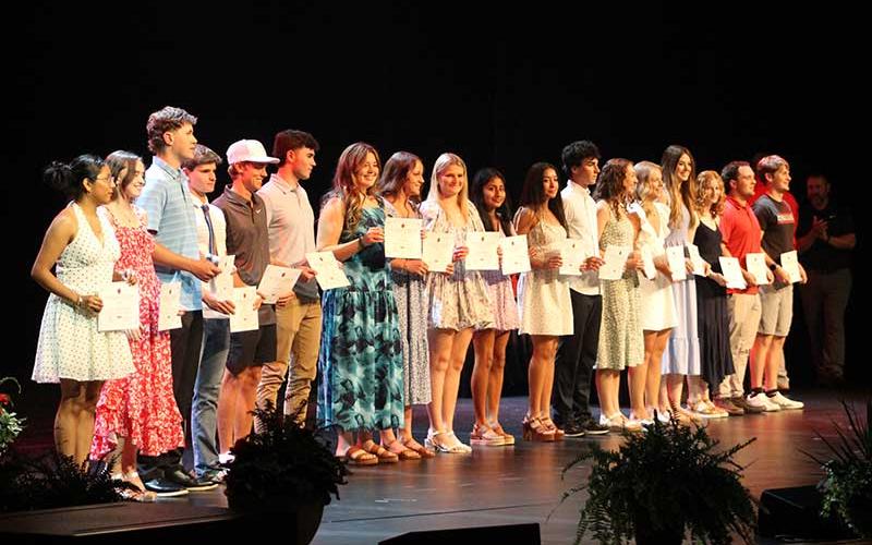 Franklin's senior scholar-athletes show off their plaques on stage at the school's annual Athletic Awards Ceremony May 28.