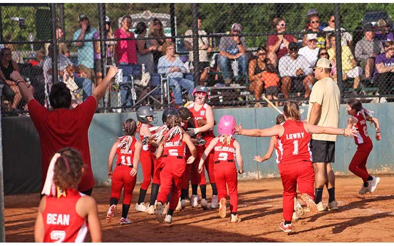 Hannah Griffith (center) is mobbed by teammates at home plate after belting a two-run homer to left field for the Franklin Coach Pitch Softball All-Stars versus Great Smokies.(Press photos/Will Woolever)