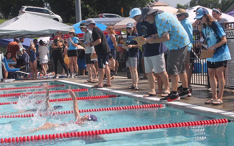 Hailey Janoe (foreground) swims a close race with Highlands' Agatha Jestin in the girls 8 &amp; under 25-yard backstroke during the Mountain Swim League Championships at the Macon County Rec Park July 18. Credit: Press photo/Will Woolever