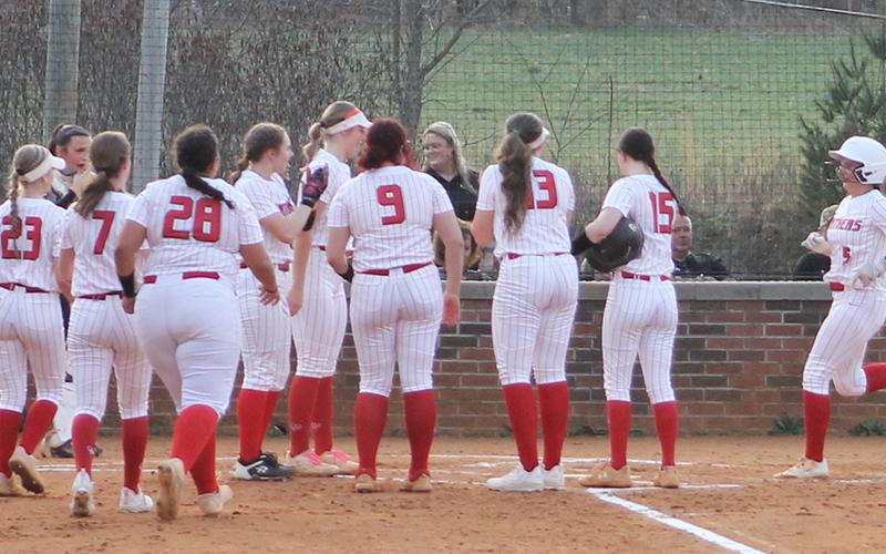 Alyssa Awtrey (right) is mobbed by teammates at home plate after belting a tw-run homer versus Murphy March 4. (Press file photo)