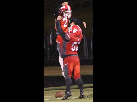 Press photo/Andy Scheidler Senior lineman Gavin Riddle celebrates with sophomore Chris McGuire after he caught a 35-yard touchdown pass on a gadget play Friday night. 