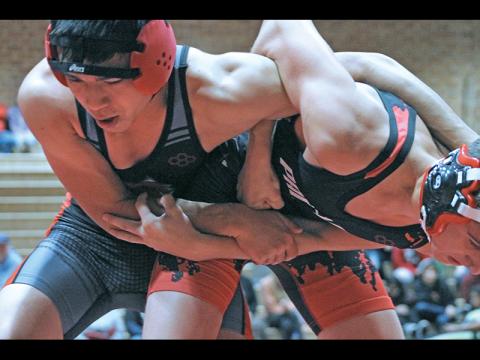 Press photo/Andy Scheidler - Aiden Carpenter (right) locks arms with an Andrews wrestler during Tuesday’s exhibition match at Macon Middle School. Carpenter, a junior, is one of three team captains for Franklin. The Panthers are set to open the season Saturday in a tournament at Swain County. 
