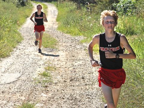 Press photo/Andy Scheidler - Ethan Stamey leads his brother Nathan by a few strides during a meet in August at Rabun Gap-Nacoochee School. The twins finished 11th and 16th at the 2-A NCHSAA Championship this past weekend in Kernersville. Franklin’s boys finished ninth, while girls placed 15th.