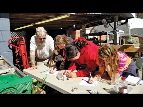 BSA scouts Anna Williamson, Trishelle Tyndell and Rose Callenback get a geology lesson with Troop 4200.