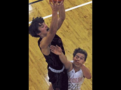 Press photo/Andy Scheidler Franklin sophomore Trey Penland rises high above a Rabun County player for a rebound. Penland scored 14 points in the road win, which saw the Panthers shoot above 50 percent for the second straight game.