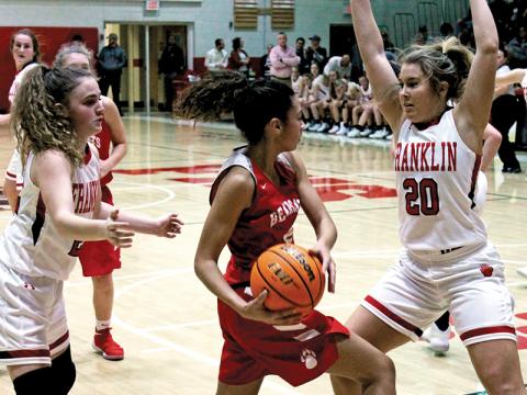 Press photo/Andy Scheidler - Taylor Carlton (20) and Kyndell Burns trap a Hendersonville player during Friday’s home game. The Panthers allowed only 31 points in the win. 