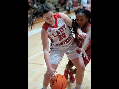 Press photo/Tom Pantaleo Abby Carpenter shields off a Hendersonville player reaching for the ball during Friday’s tournament game.