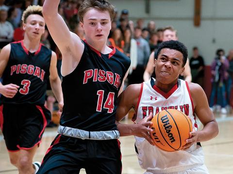 Press photos/Tom Pantaleo - Chad Wilson drives to the hoop while Pisgah’s Max Wait tries to cut him off during action Friday. Franklin avenged a 53-30 loss to the Black Bears by winning another low-scoring battle, 46-43. 
