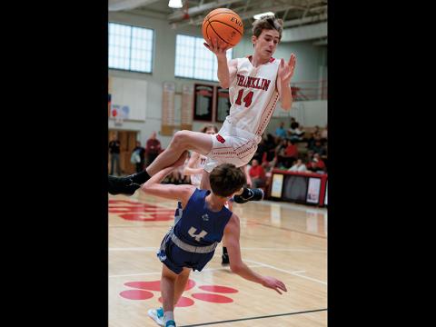 Press photo/Tom Pantaleo Franklin’s Devyn Blackburn gets some serious elevation while a Brevard player tries taking a charge. Fortunately, neither player got injured on the collision. 