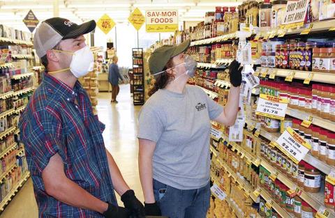 Press photo/Jake Browning - Max Falcon and Megan Nicholson wear masks to protect themselves on a shopping trip to Sav-Mor.