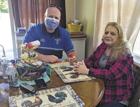 Photo submitted Joey Gibson, coordinator of the Community Care paramedic program, visits with Reba Wyatt.