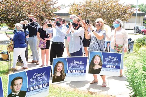 Press photo/Linda Mathias - Families and loved ones take photos as students participated in a graduation ceremony at Macon Early College.