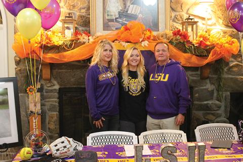 Press Photo/Will Woolever - Senior outfielder Mckenzie Redoutey stands with her mother, Deborah, and her father, Scott, after signing her official offer to LSU last week. Redouty will join a team with four Women’s College World Series berths in the past eight years.