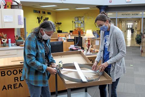 Press photo/Jake Browning - Teachers Jennifer Love and Kelsea Youmans assemble a rolling base that makes a Tower Garden mobile.