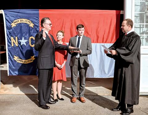 Photo submitted - Karl Gillespie was sworn in as the NC House representative for the 120th district by newly elected 30th District Court Judge Kaleb Wingate as Gillespie’s wife, Janet, and son, Logan look on.