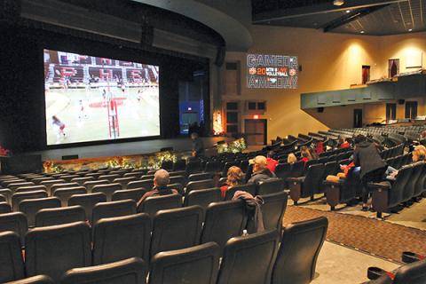 Press Photo/Will Woolever - Panther volleyball fans watch a recent game on the big screen at the Smoky Montain Center for the Performing Arts. The theater has been showing live broadcasts of FHS games for fans unable to attend.
