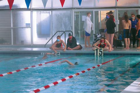 Press Photo/Will Woolever FHS swimmers Natalie Ballard (left) and Olivia Stahl help teammates keep track of how many laps they’ve swum  in the 500-meter freestyle against Smoky Mountain. The event requires swimmers to go ten laps, or twenty lengths of the pool.