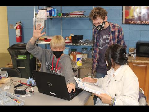 Press photo/Jake Browning - Hunter Kroeger, Jude McIntee and Giuliana Mendoza during a meeting of the Macon Bots robotics team.