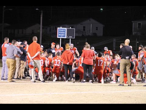 Press photo/Will Woolever - FHS head football coach Josh Brooks (center left) addresses his team following his last game, a home win against Smoky Mountain April 9.