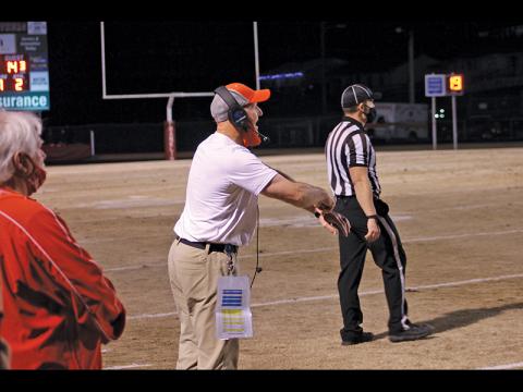 File photo - Longtime FHS football coach Josh Brooks coaches up his players from the sideline against Hendersonville March 12.