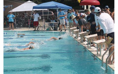 Press photo/Will Woolever - Timers watch a close finish in the boys’ 11-12 100-yard freestyle at the Mountain Swim League All-Star Meet July 24.