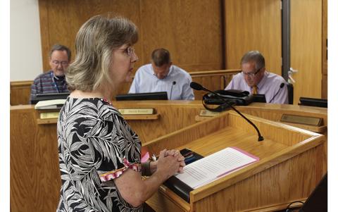 Press photo/Jake Browning - KIDS Place executive director Alisa Ashe addresses the Macon County Board of Commissioners about cuts to the Victims of Crime Act Fund.