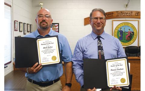 Press photo/Jake Browning - Mark Sutton (left) of Macon Early College was recognized as Principal of the Year and Thomas Graham of Macon Middle School received Teacher of the Year honors at the School Board meeting on Aug. 23. Christina Tallent, a teacher assistant at Cartoogechaye Elementary School, was named Support Person of the Year. 