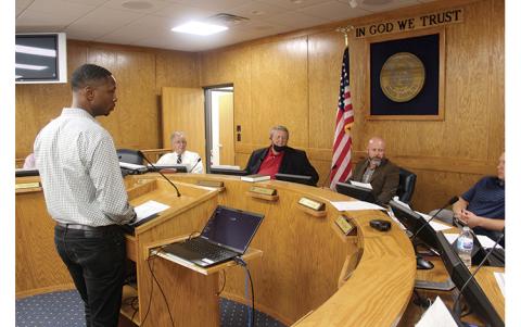 Press photo/Jake Browning - Chris Coleman of SGA NarmourWright addresses the Macon County Board of Commissioners about unexpected expenses in the Macon Middle School renovation project, set to be completed in fall 2022.