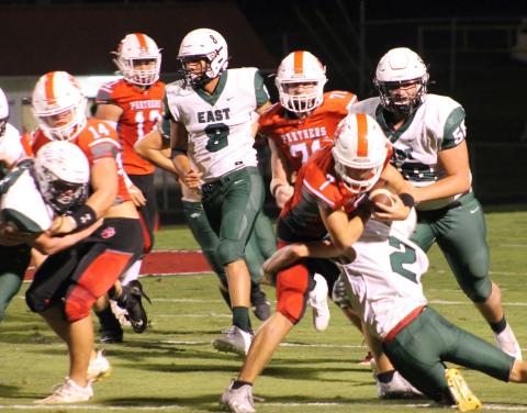 Press Photo/Will Woolever - Senior tailback/defensive back Kellen Stiles tries to shed a tackle against East Henderson Sept. 17. Stiles earned Wayah Insurance Player of the Game honors against North Henderson with 119 all-purpose yards,  two touchdowns, and a fumble recovery.