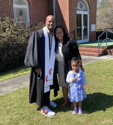 Pastor D’Andre Ash with his wife and daughter.