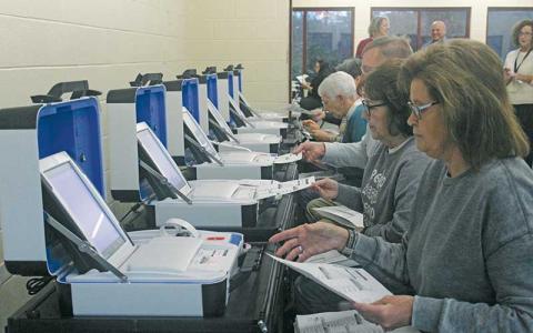 Press photo/Thomas Sherrill - Election workers try out the new HART Verity Touch Writer ballot counting machines during an election simulation on Jan. 25. The Macon County Board of Elections has requested the purchase of new voting machines and the simulation was part of the required process before buying the machines. 
