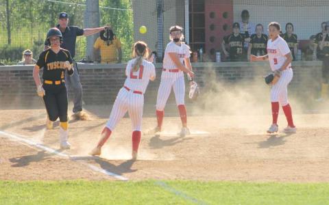 Press photo/Will Woolever - Freshman pitcher Kendall Rumans throws to senior Tessa Dehart at first in Franklin’s 12-5 victory over Tuscola April 18.