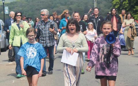 Press photo/Thomas Sherrill - Gracie Parker, megaphone in hand, leads a march to and from Franklin Town Hall to deliver a list of goals of her Mental Health Help Rally on Sunday, April 30.