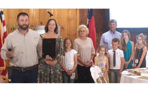 Press photo/Thomas Sherrill - With his family, Adam Huscusson talks about what it means to receive the North Carolina Outstanding Conservation Farm Family of the Year award.