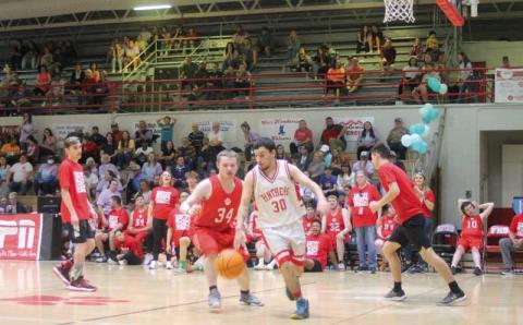 Press file photo - Senior Johnathon Collier is pictured grabbing a rebound in the fourth annual UNIFY March Madness game this spring.
