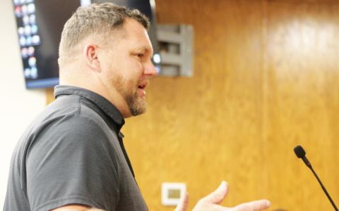 Press photo/Thomas Sherrill - New Union Academy Principal Brian Moffitt speaks to the Macon County Board of Commissioners during the July 11 meeting.