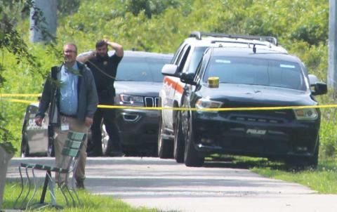 Press photo/Thomas Sherrill - A section of the Greenway was closed Monday morning as emergency workers recovered a body from the river.