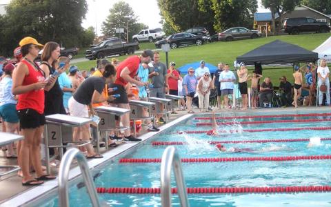 Press photo/Wiill Woolever - Timers watch a close finish between FAST’s Abigail Duvall (foreground) and Maggie Jamison in the girls 11-12 50-yard backstroke July 6. 