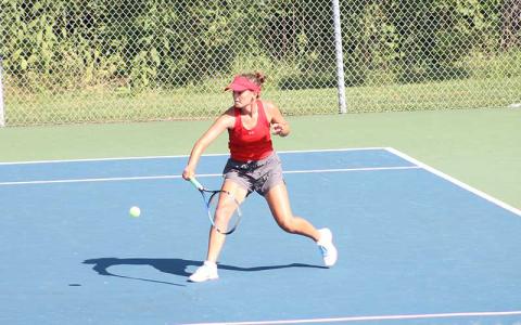 Press photo/Will Woolever - Junior Kate Phillips attempts a groundstroke in a recent match at the Macon County Rec Park.