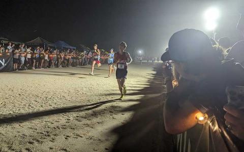 Photo courtesy of Melissa Ward - Junior Cooper Tyler crosses the finish line at the Friday Night Lights Cross Country Festival Sept. 8. 