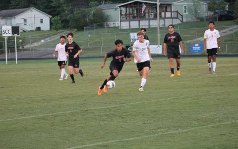 Press photo/Will Woolever - Junior Miguel Cruz tries to evade an East Henderson defender Sept. 11.