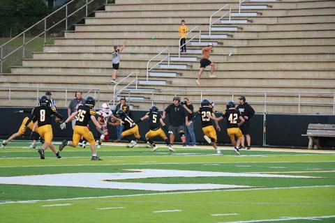 Photo courtesy of Blair King  - Sophomore wide receiver/defensive back Mark Vanhook tries to break a tackle against Tuscola Sept. 21.