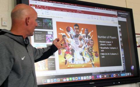 Press photo/Thomas Sherrill - Franklin High Career and Technical Education teacher Josh Brooks gives a presentation on Esports to the Macon County Board of Education Dec. 21.