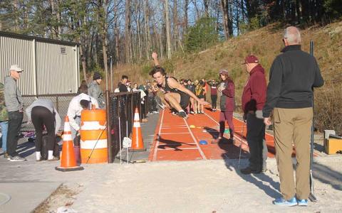 Press photo/Will Woolever - Junior Braylen Dezarn competes in the long jump at Swain Nov. 29.