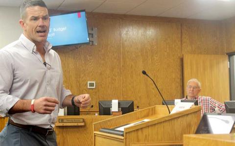 Press photo/Thomas Sherrill - County Manager Derek Roland presents a $180 million spending plan during the Feb. 8 budget kickoff meeting. Looking on is commissioner Paul Higdon.