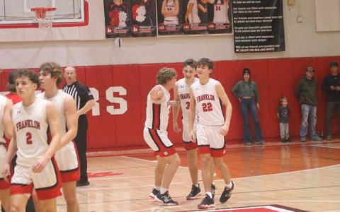 Junior guard Max McClure (center) celebrates with junior center Brayden Hervey (left) and junior forward Brennan Cabe after sinking a game-winning 3-pointer versus Pisgah Jan. 30. (Press photo/Will Woolever)