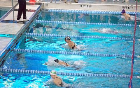 Senior Claire Ballard (top) competes in the 100-yard breaststroke at the 3A State Championship Feb. 8. She placed seventh overall and broke her own school record with a time of 1:10.92.